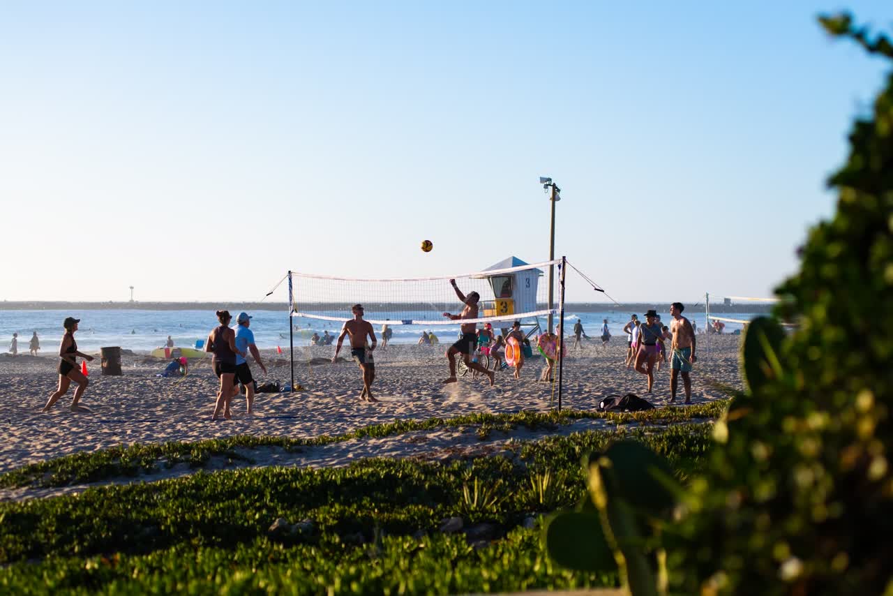 The beach, the ocean and open country in Ocean Beach, with swimmers in the water.