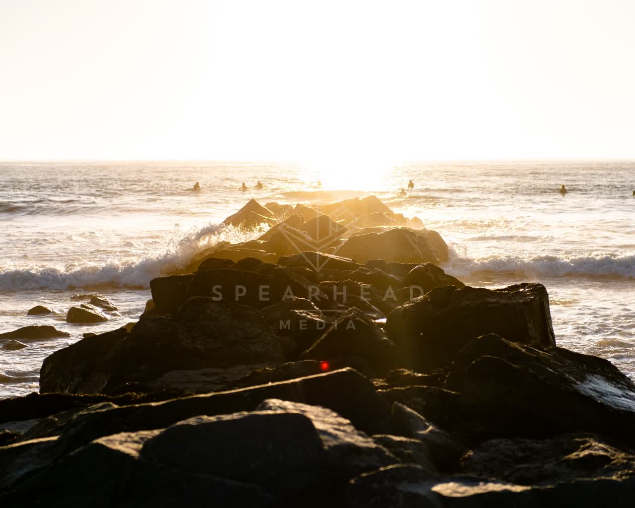 The beach, the surf and the ocean in Ocean Beach, with swimmers in the water.