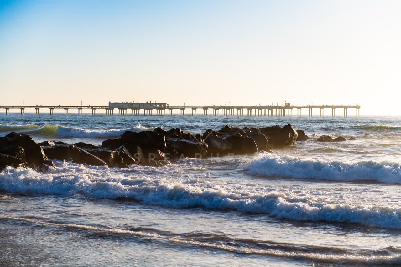 View from the water of the beach, the surf and the pier in Ocean Beach.
