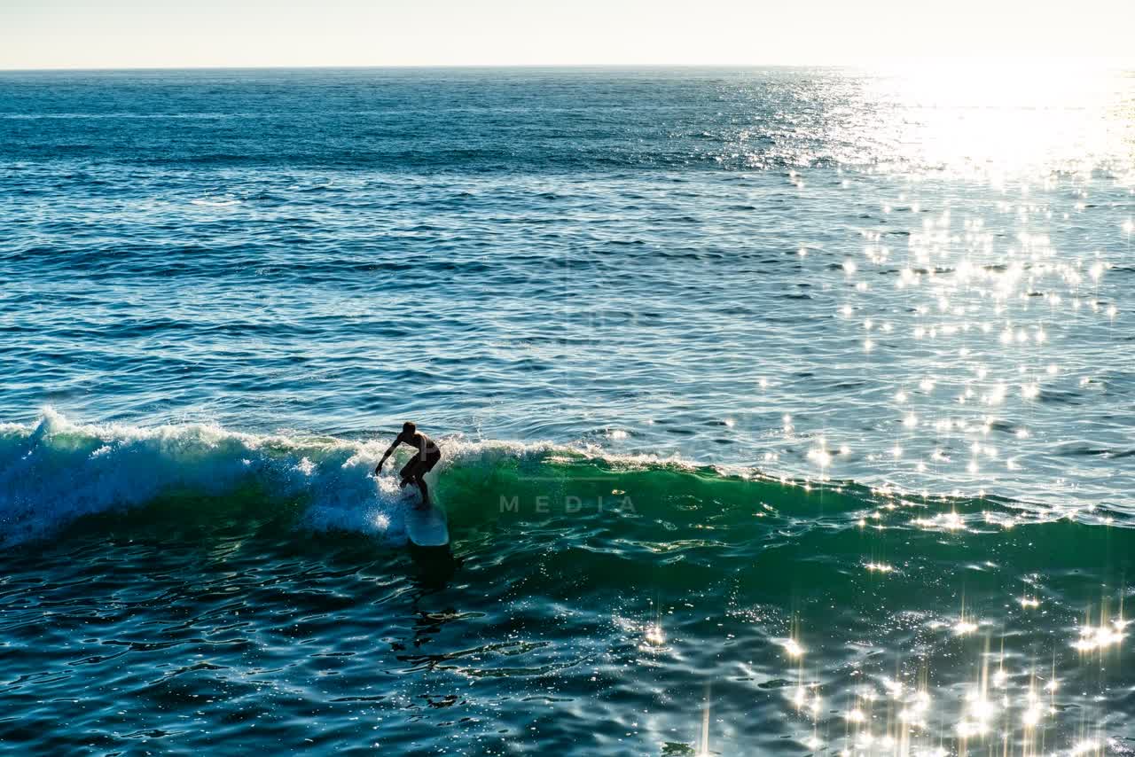 The beach, the surf and the ocean in Ocean Beach, with surfers out.
