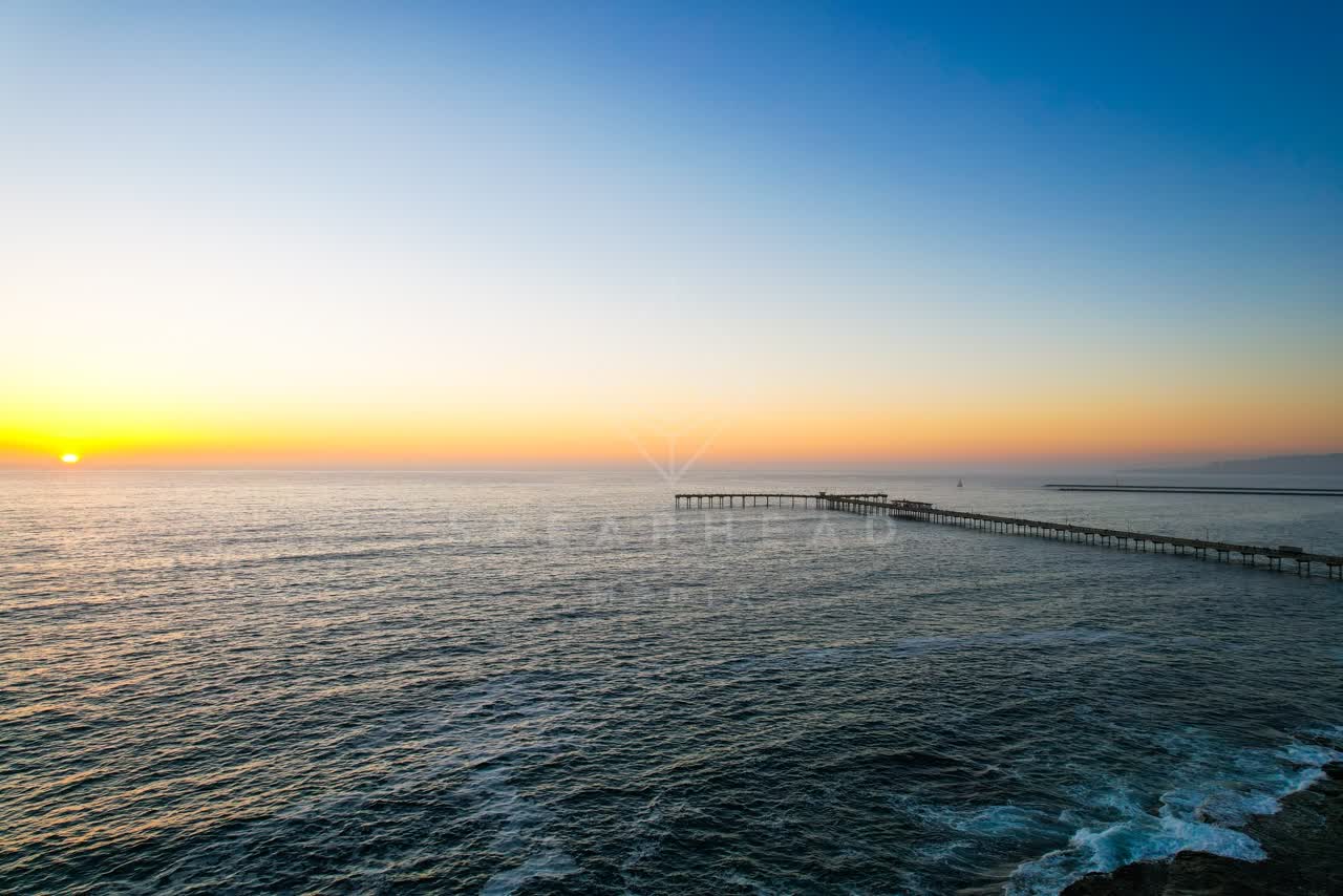 Low aerial view of the beach, the pier and the ocean in Ocean Beach.