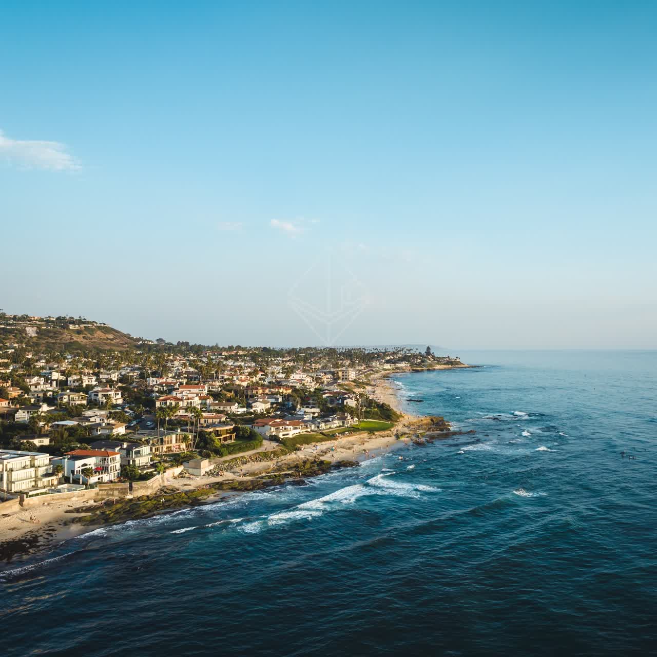Aerial view of the beach, the surf and palm trees at Windansea.