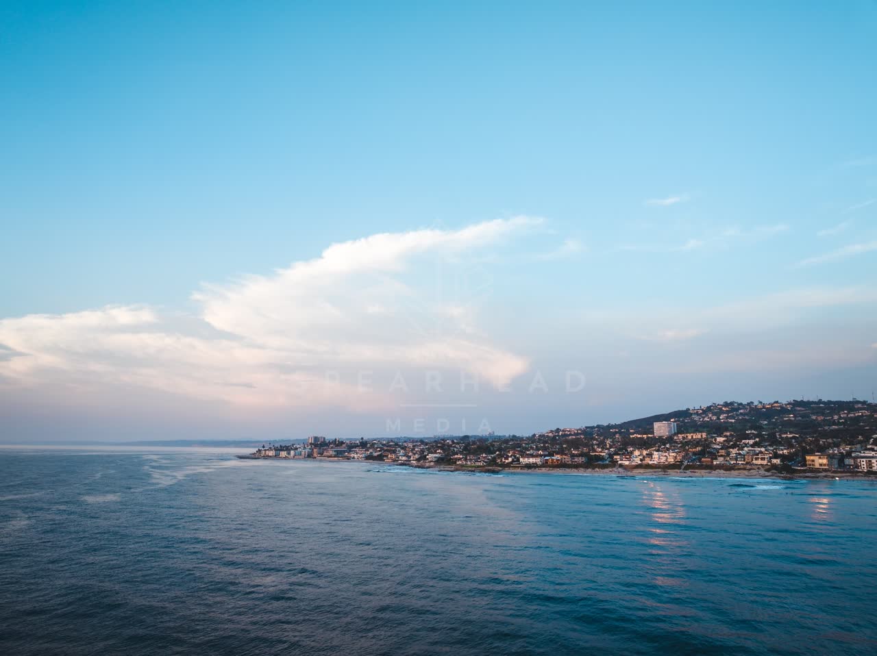Aerial view of the cliffs, the ocean and homes at Windansea.