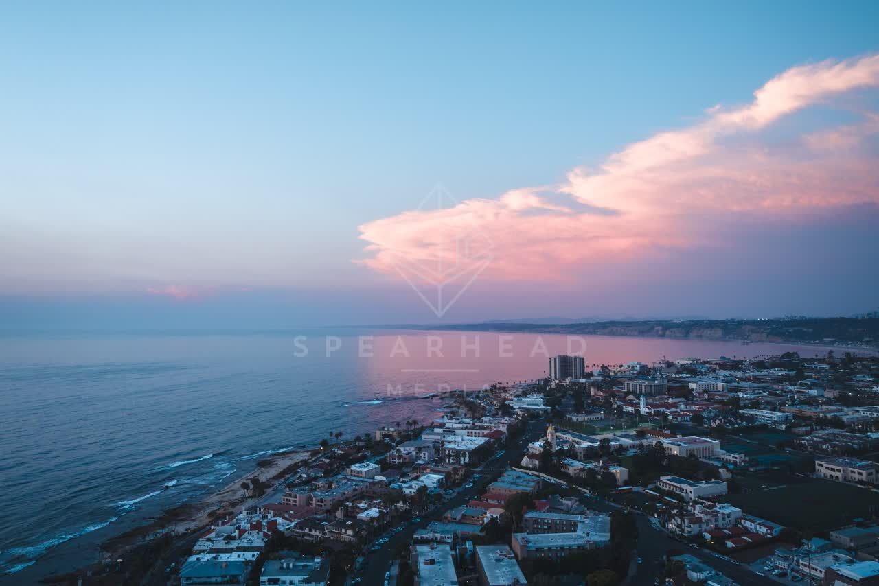 Aerial view of a residential street, the ocean and homes at Village of La Jolla.