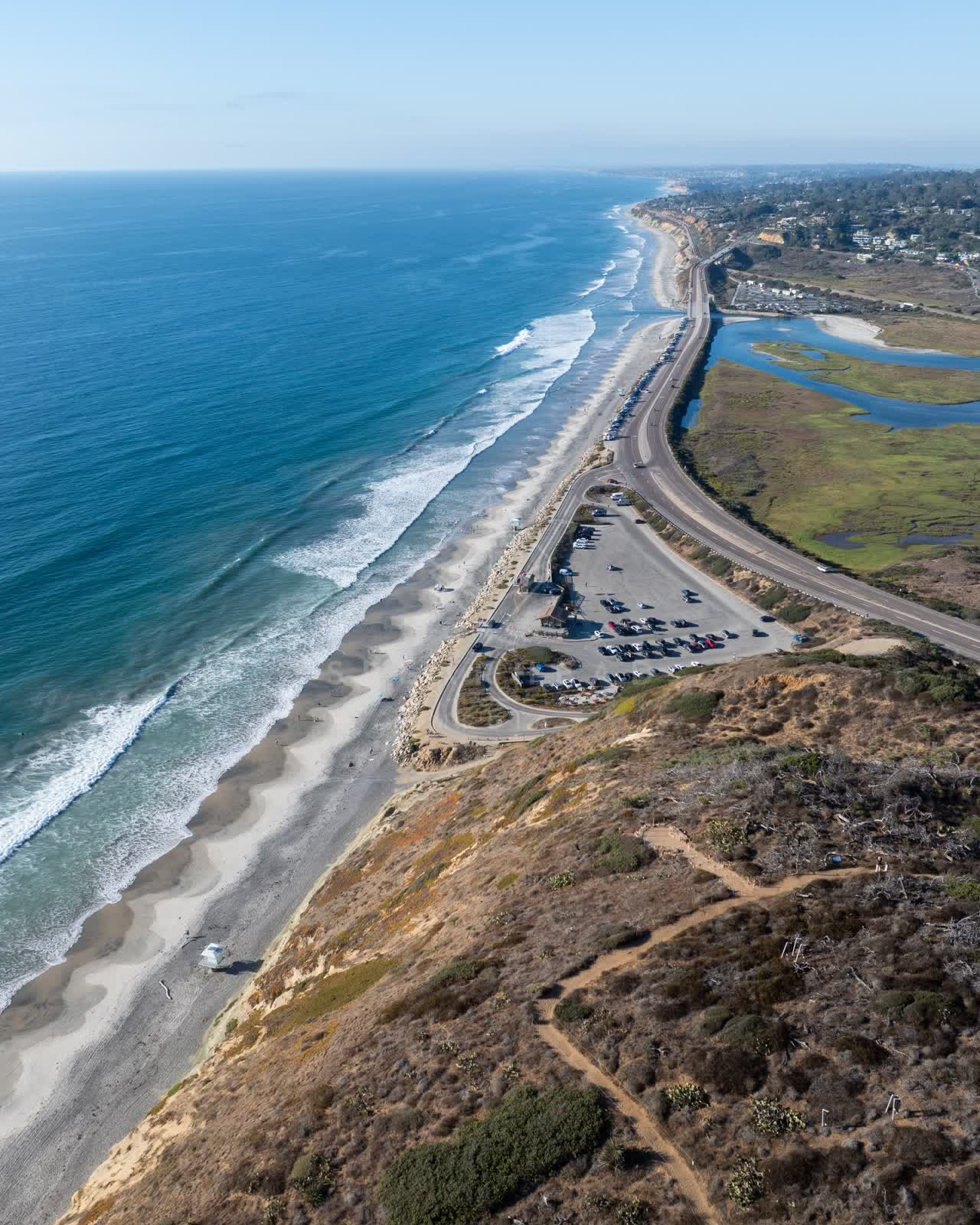 Aerial view of the cliffs, the surf and the ocean at Torrey Pines.
