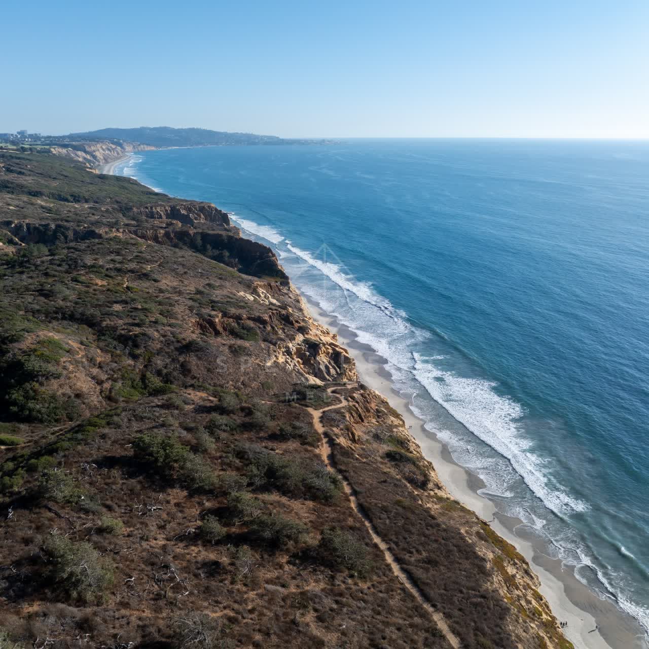 Aerial view of the cliffs, the surf and the ocean at Torrey Pines.