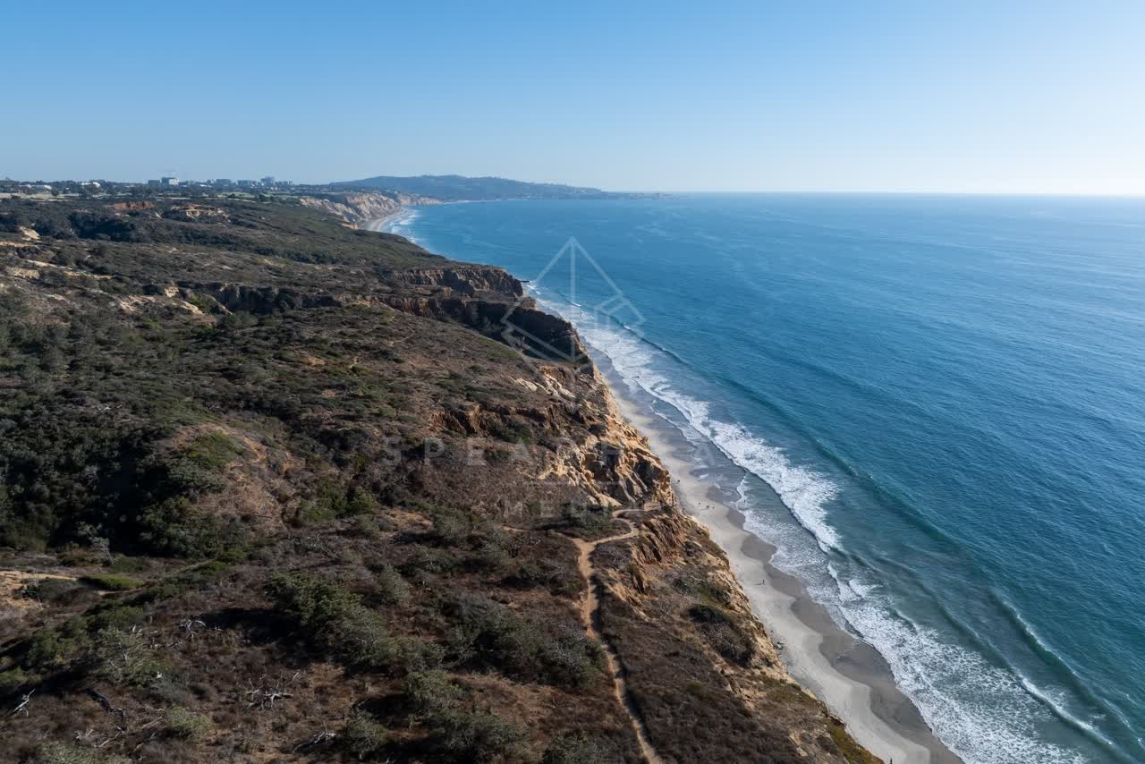 Aerial view of the cliffs, the surf and the ocean at Torrey Pines.