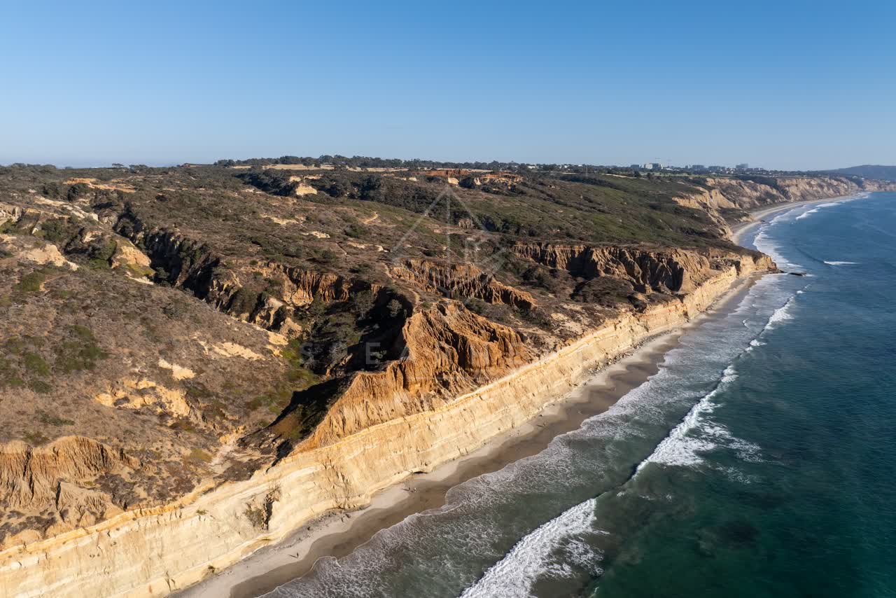 Aerial view of the cliffs, the surf and the ocean at Torrey Pines.
