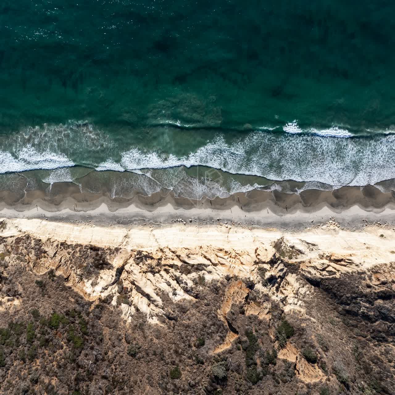 Aerial view of the cliffs, the surf and the ocean at Torrey Pines.
