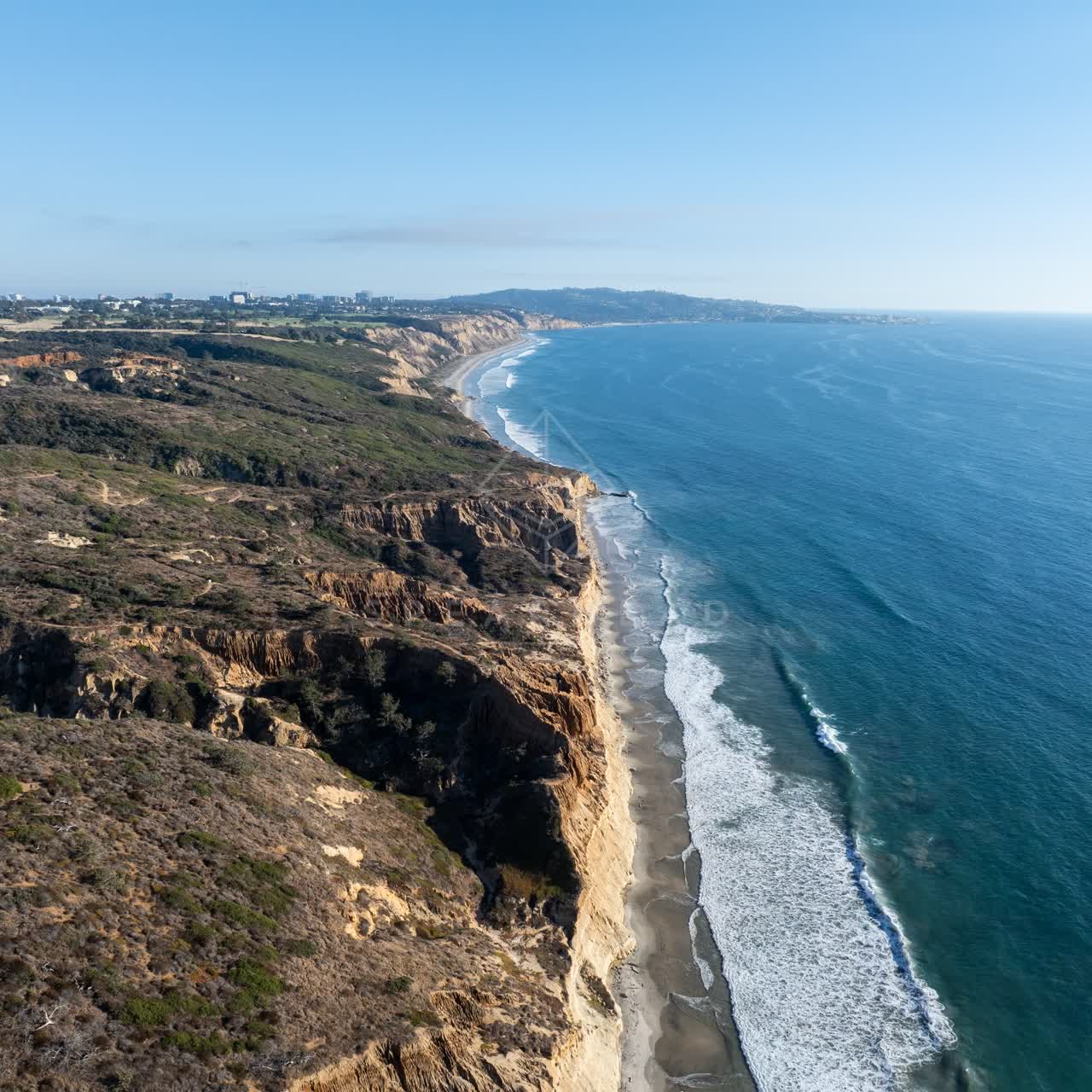 Aerial view of the cliffs, the surf and the ocean at Torrey Pines.