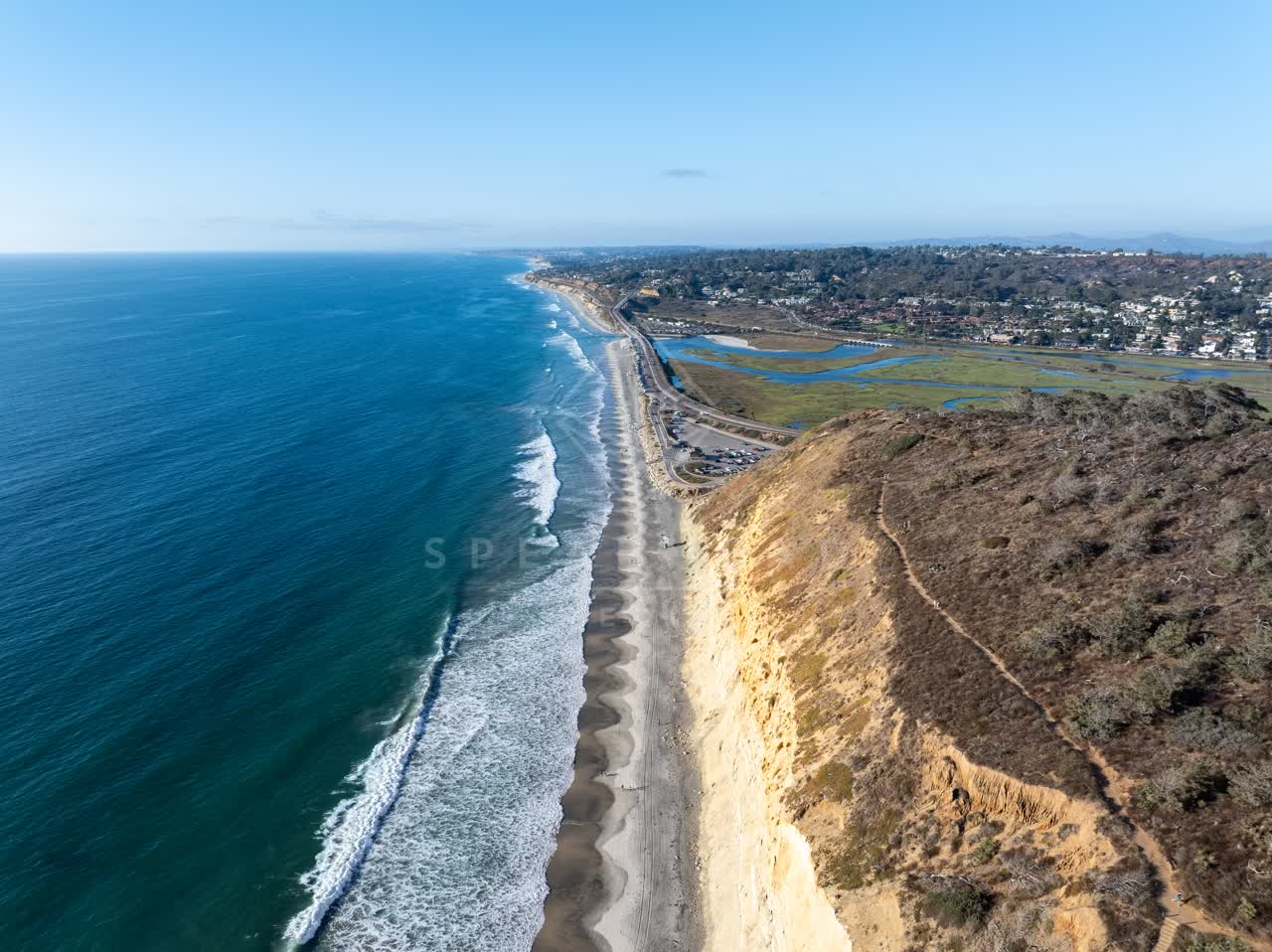 Aerial view of the cliffs, the surf and the ocean at Torrey Pines.