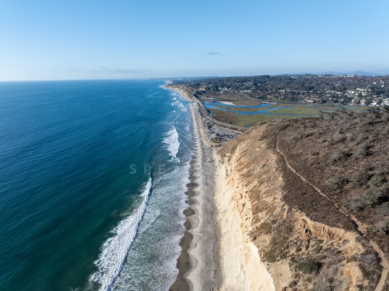 Aerial view of the cliffs, the surf and the ocean at Torrey Pines.