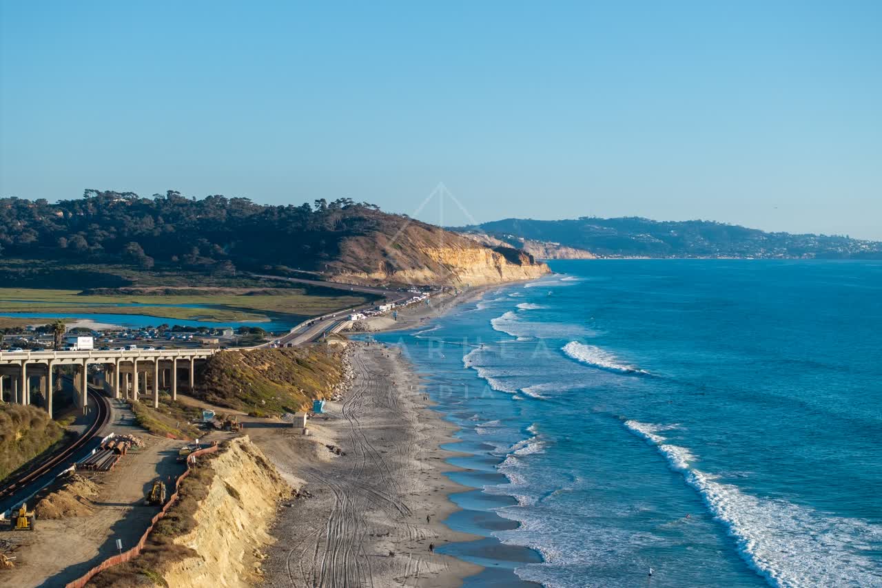 Aerial view of the cliffs, the surf and the bridge in Del Mar.