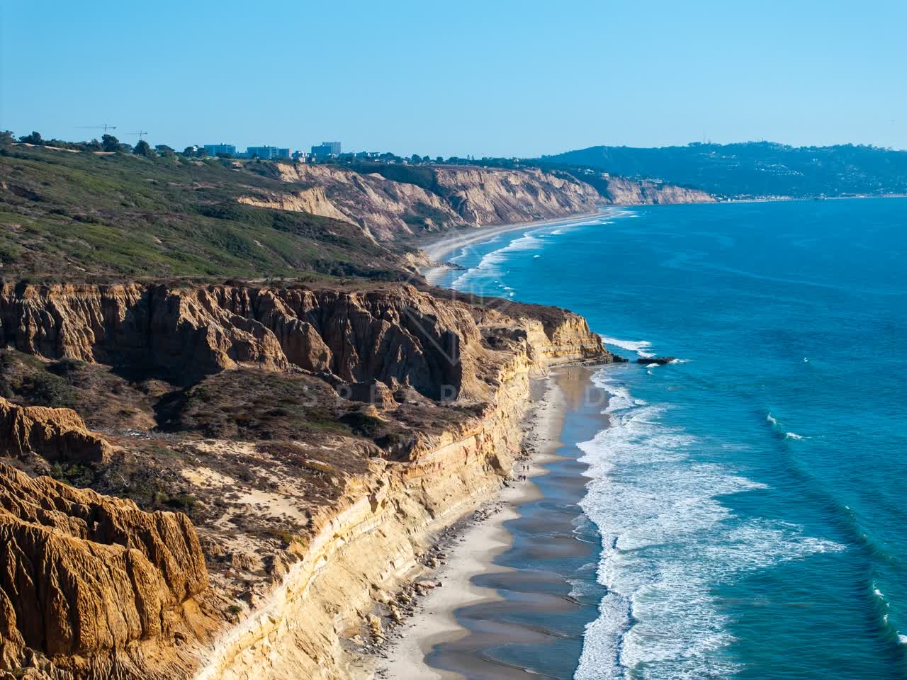 Aerial view of the cliffs, the surf and the ocean at Torrey Pines.