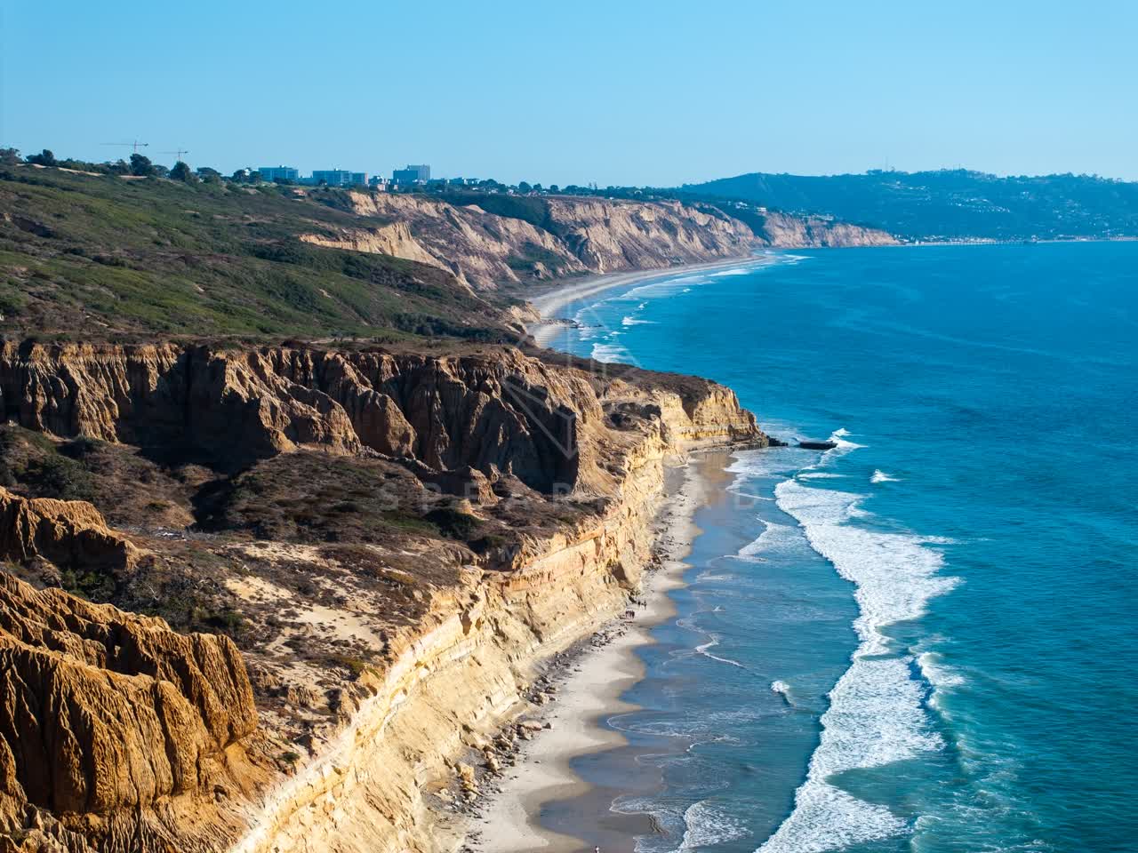 Aerial view of the cliffs, the surf and the ocean at Torrey Pines.