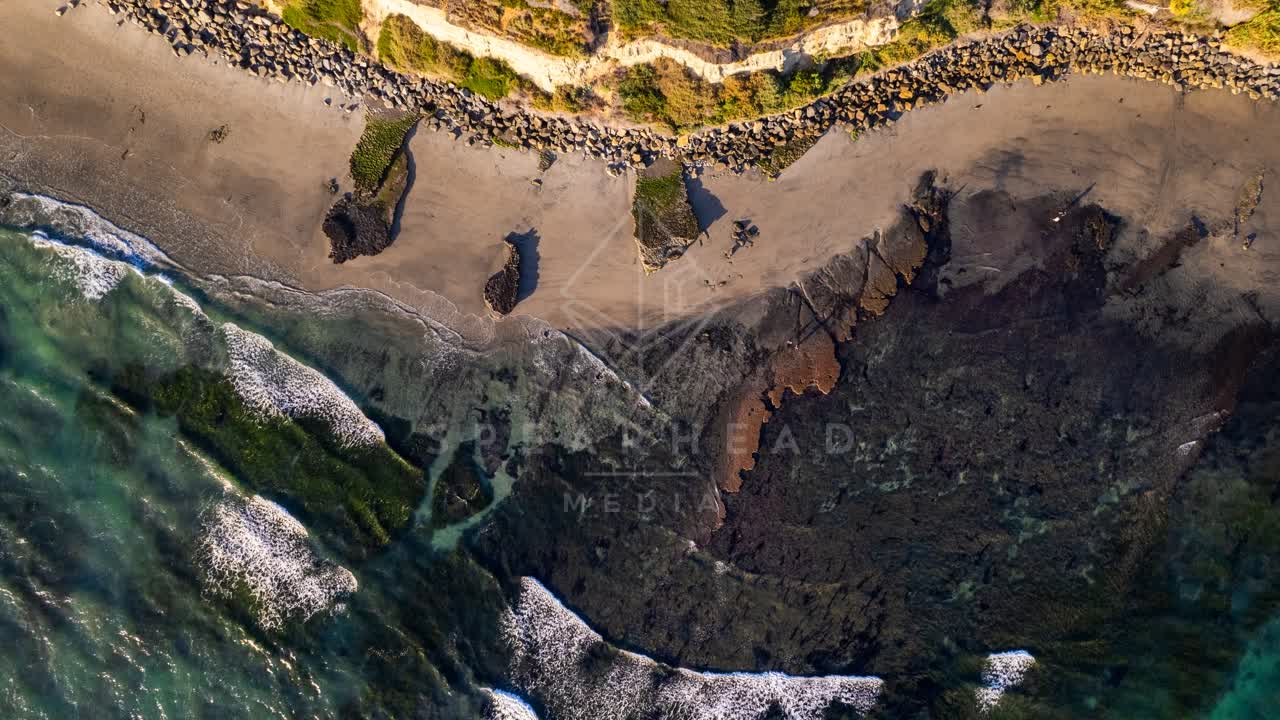 Aerial view of the beach, the surf and the ocean at Swamis.