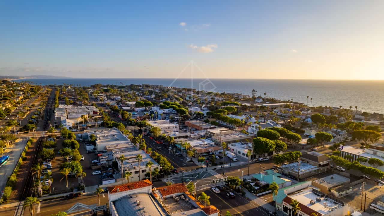 Aerial view of a residential street, palm trees and the ocean at Downtown Encinitas.