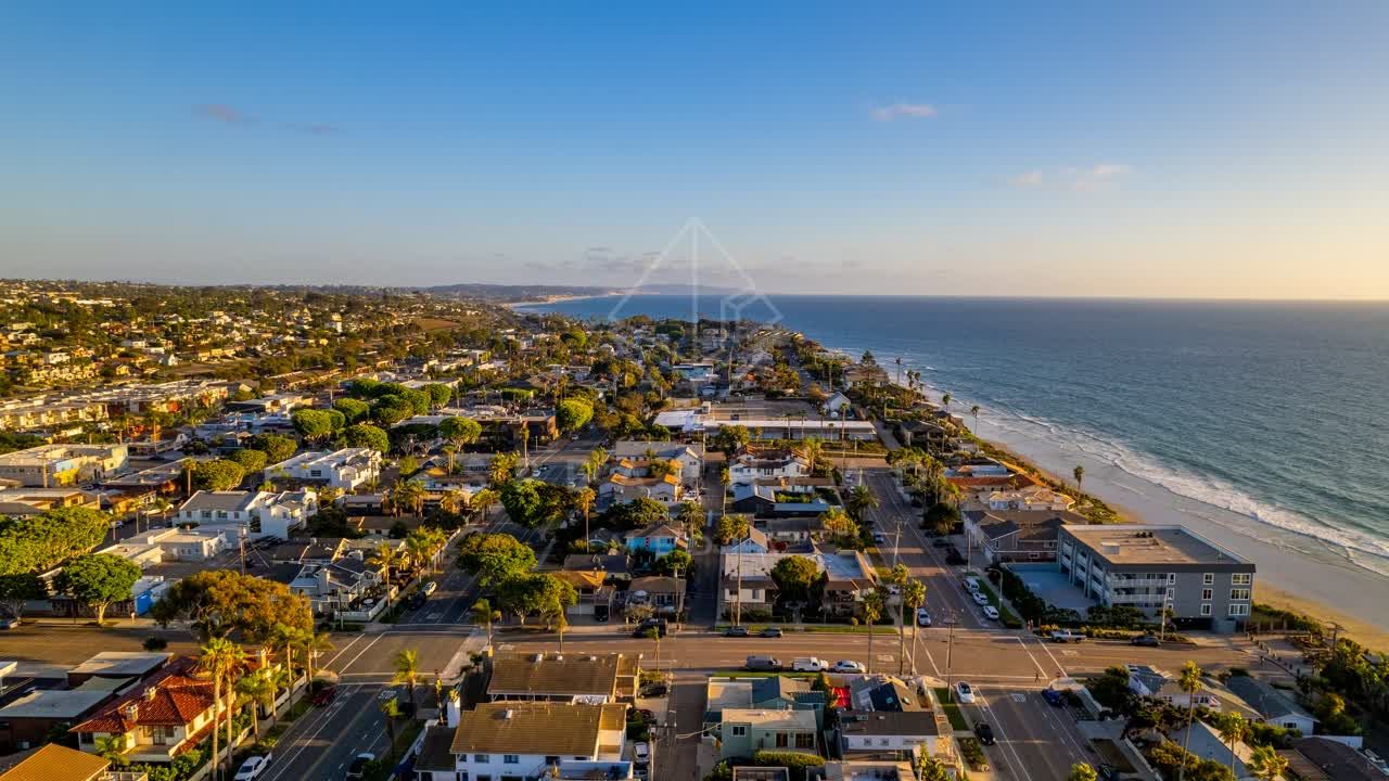 Aerial view of a residential street, palm trees and the ocean at Downtown Encinitas.
