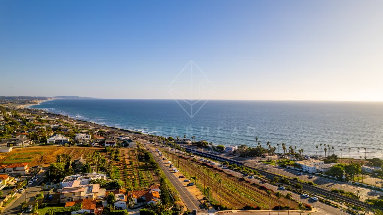 Aerial view of a residential street, palm trees and the ocean at Swamis.
