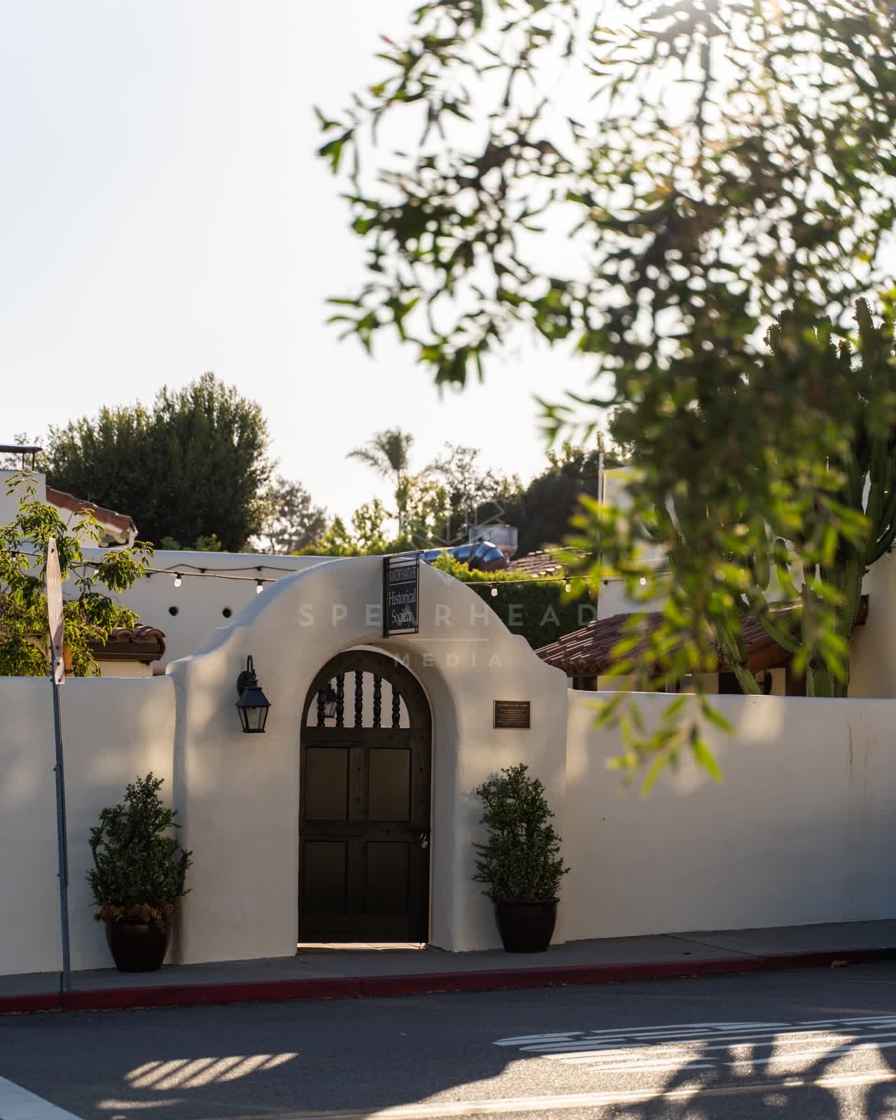 A residential street, palm trees and the buildings at Covenant.