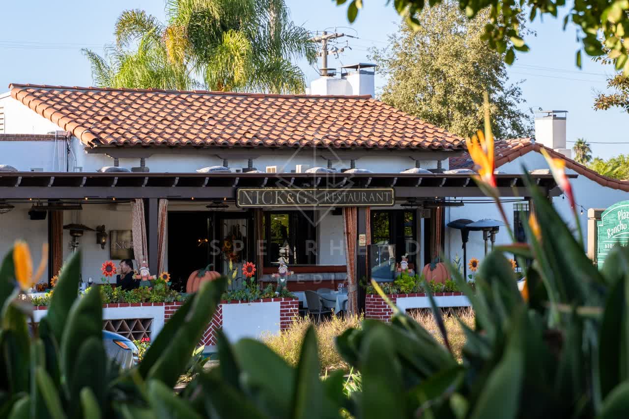 The downtown streets, palm trees and homes at Covenant, with people eating outside.