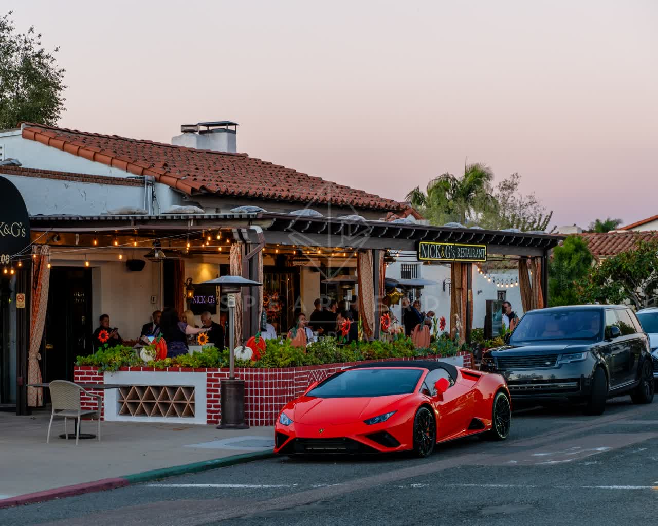 The downtown streets, palm trees and the buildings at Covenant, with people eating outside.