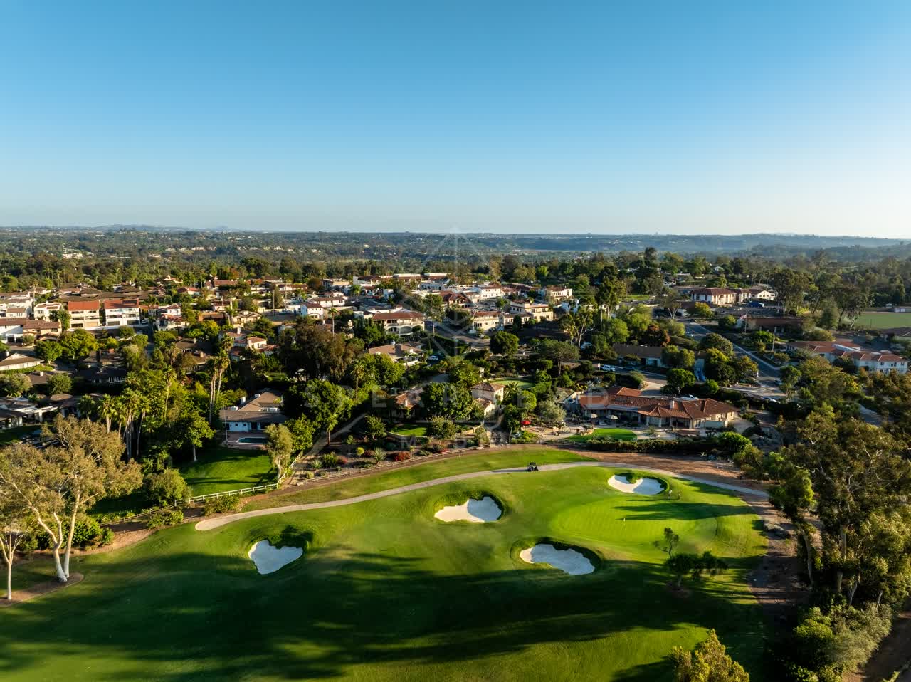Aerial view of a residential street, homes and open country at Covenant.