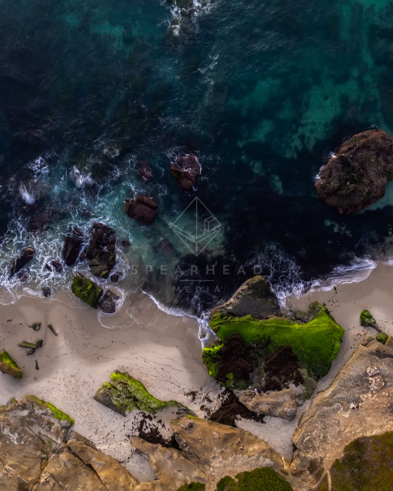 Aerial view of the beach, the surf and the ocean at Windansea.