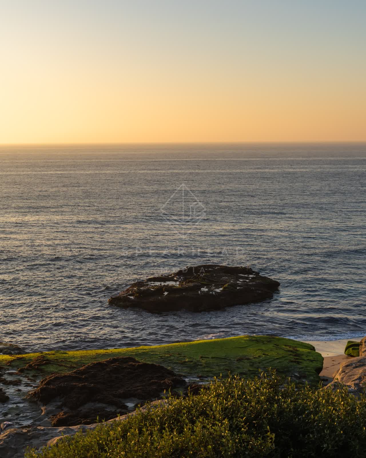 Elevated view of the cliffs, the ocean and open country at Windansea.