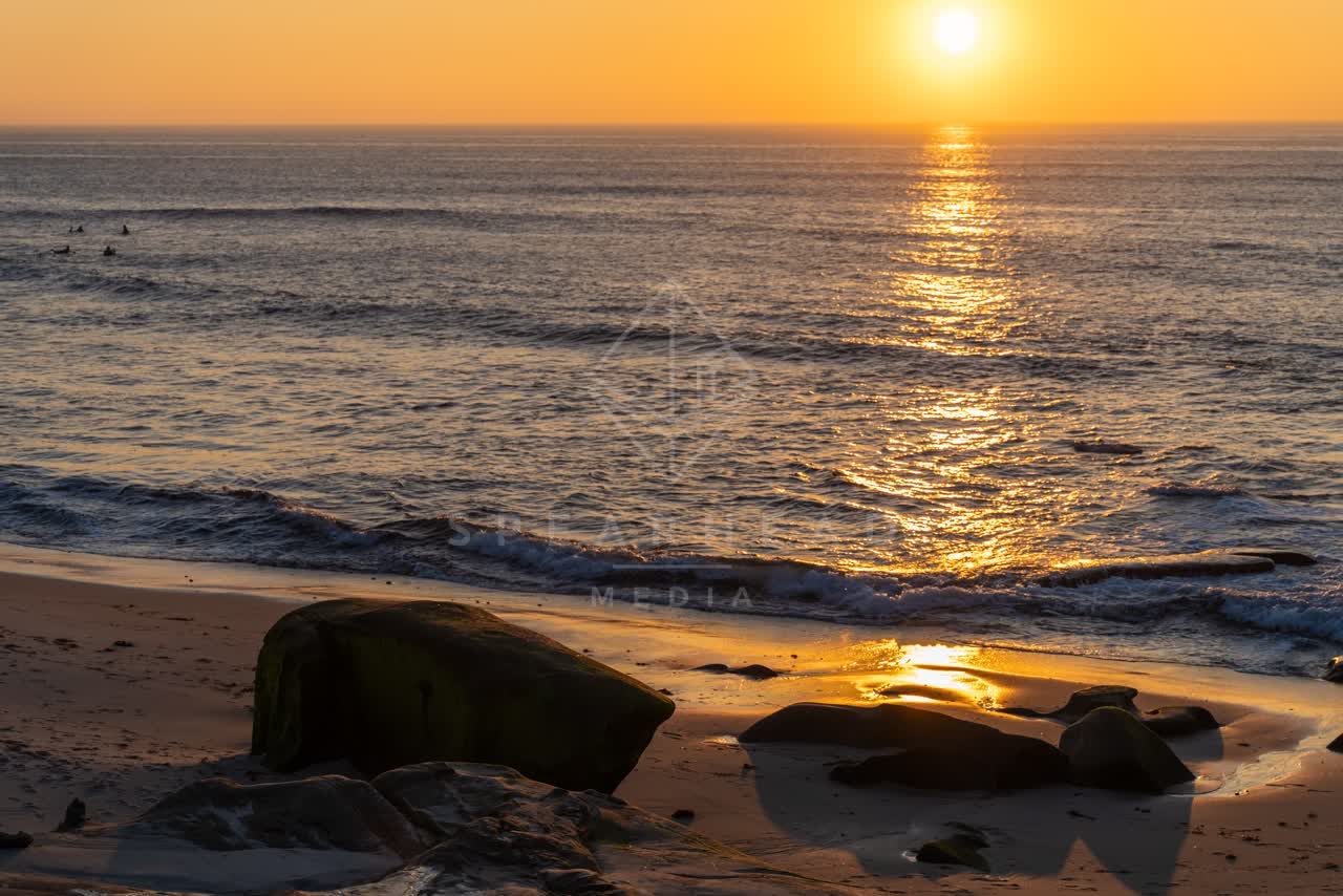 The beach, the surf and the ocean at Windansea, with surfers out.