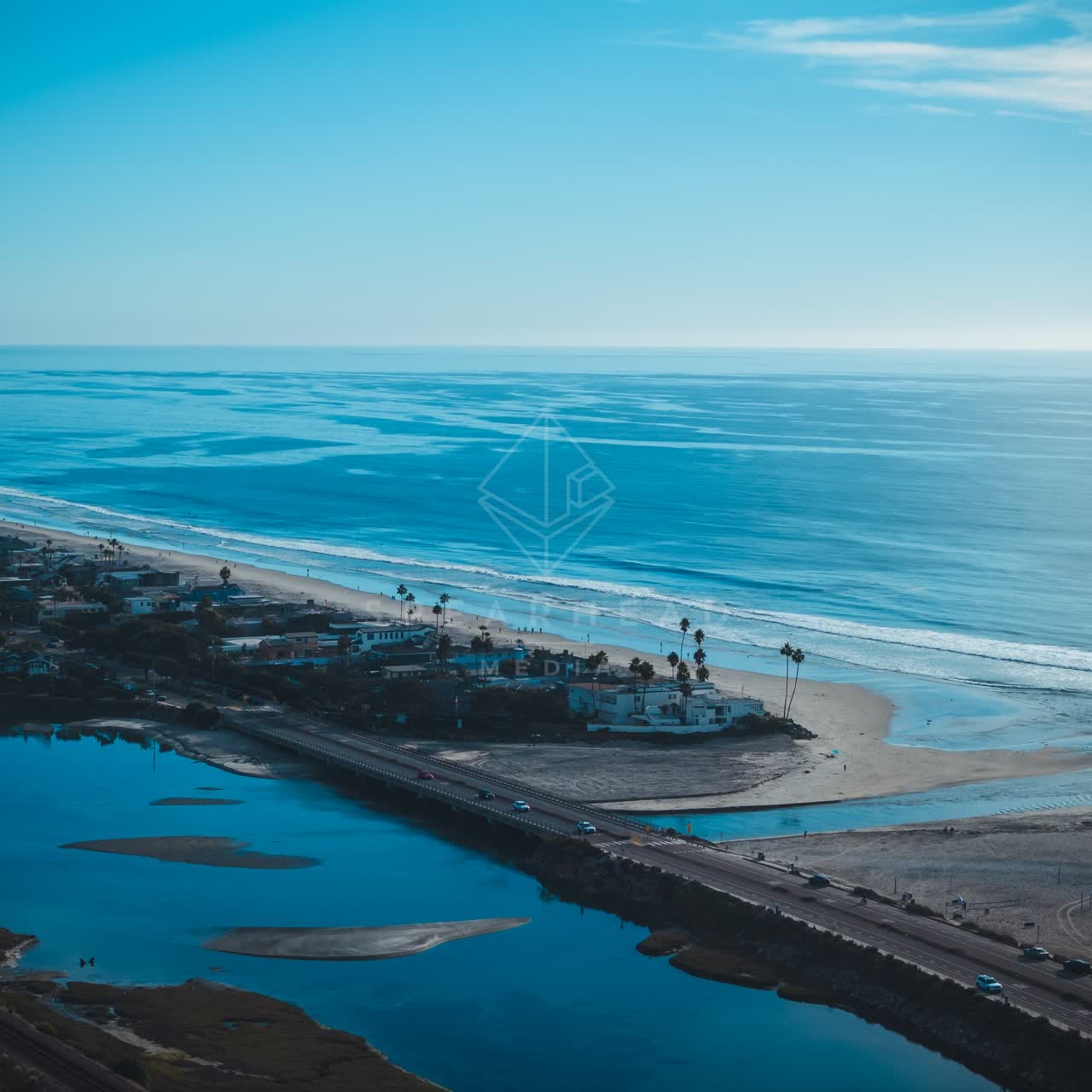 Aerial view of the beach, the bridge and palm trees at Del Mar Dog Beach.