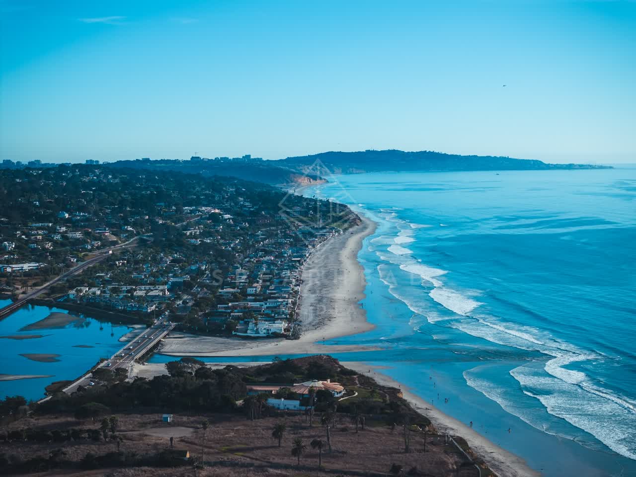 Aerial view of the beach, the surf and the ocean at Del Mar Dog Beach.