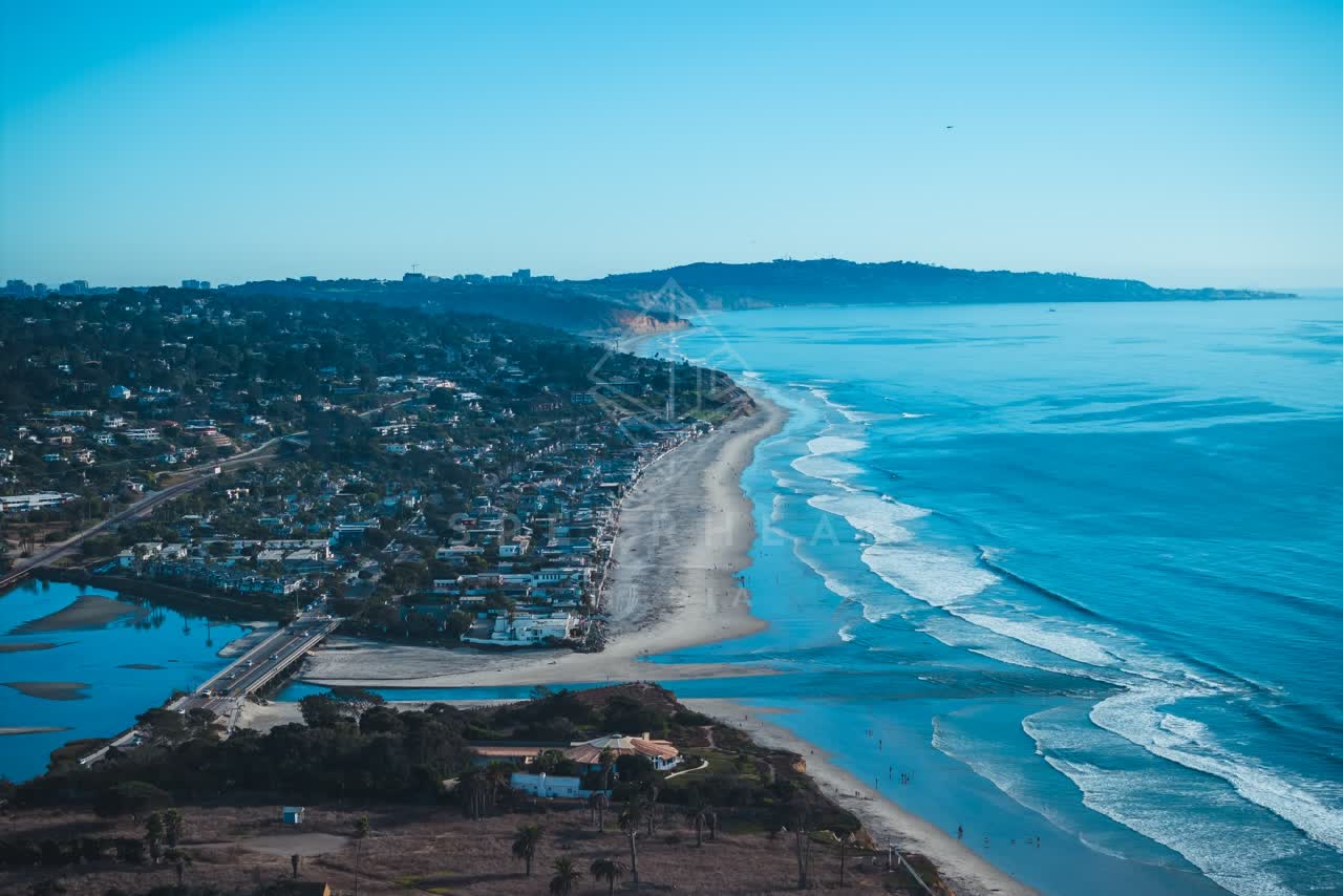 Aerial view of the beach, the surf and the ocean at Del Mar Dog Beach.