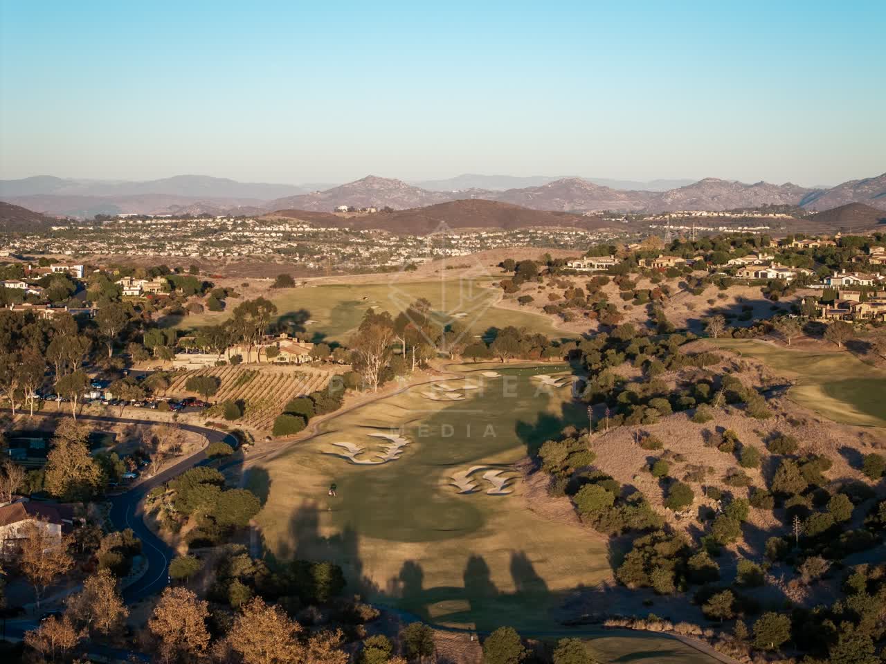 Aerial view of the country inland, homes and open country in Santaluz.