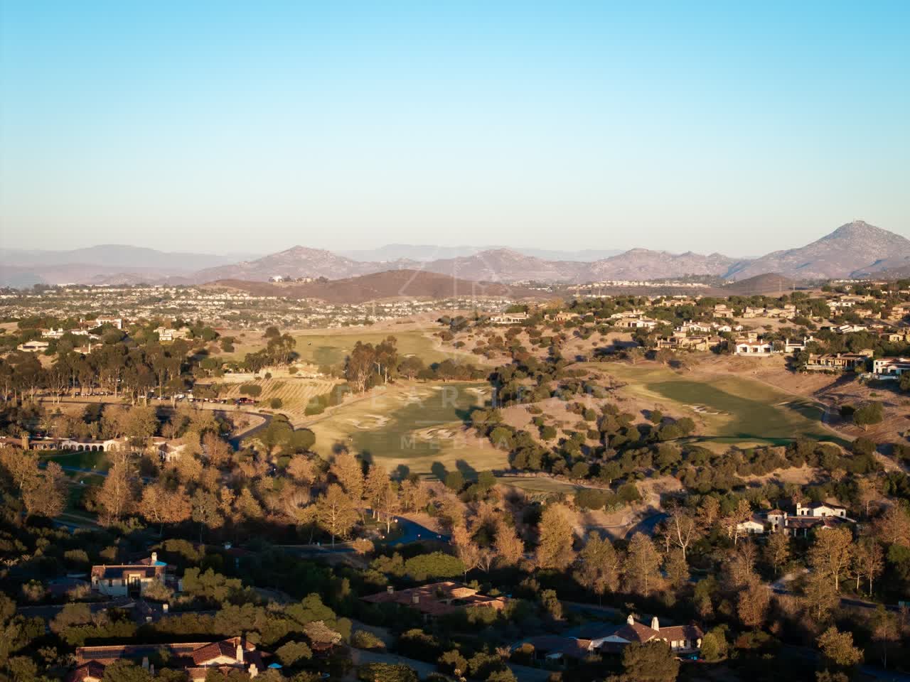 Aerial view of the country inland, homes and open country in Santaluz.