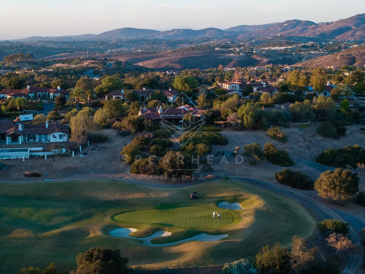 Aerial view of the country inland, homes and the buildings in Santaluz, with people walking.