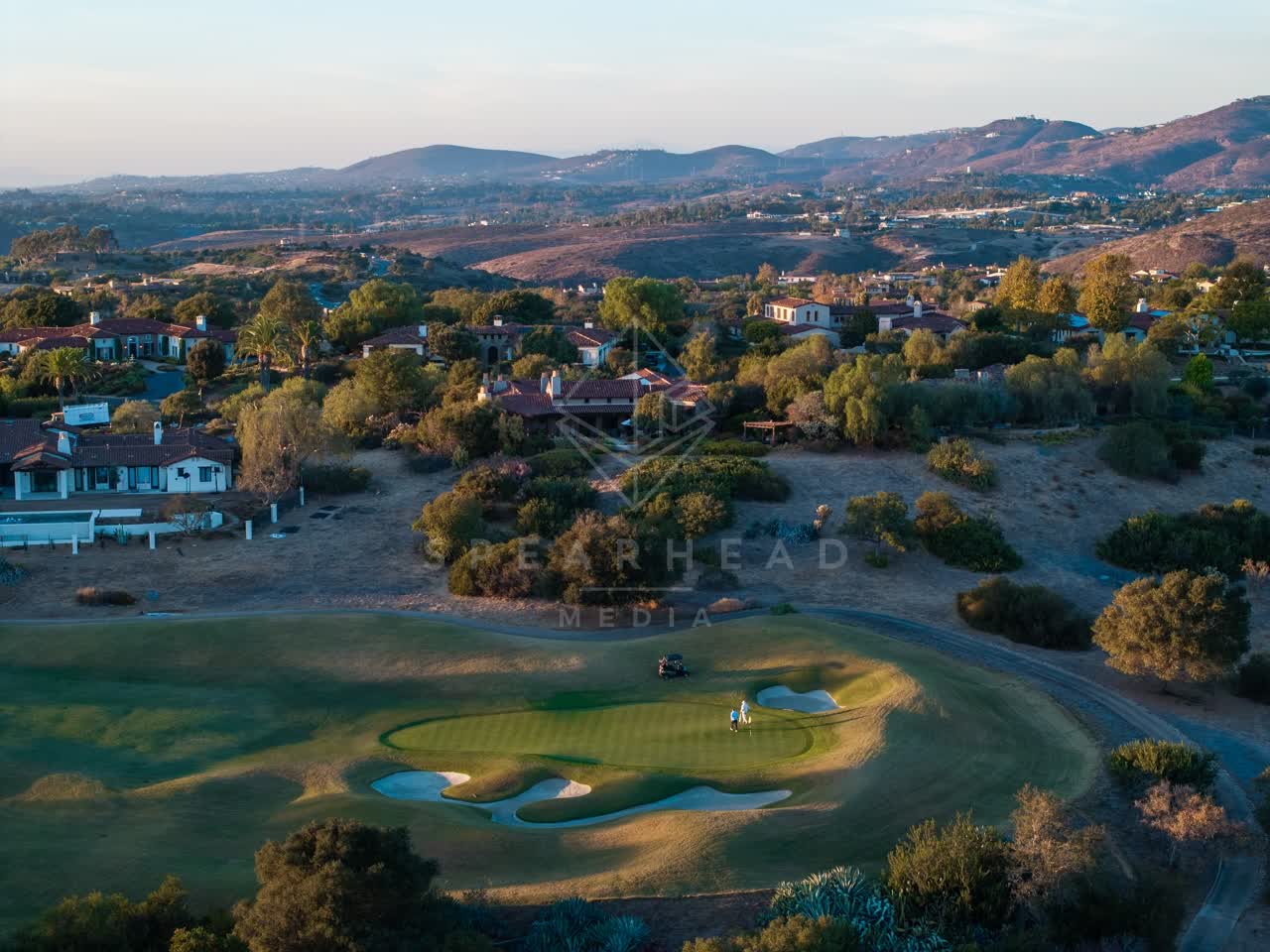 Aerial view of the country inland, homes and the buildings in Santaluz, with people walking.