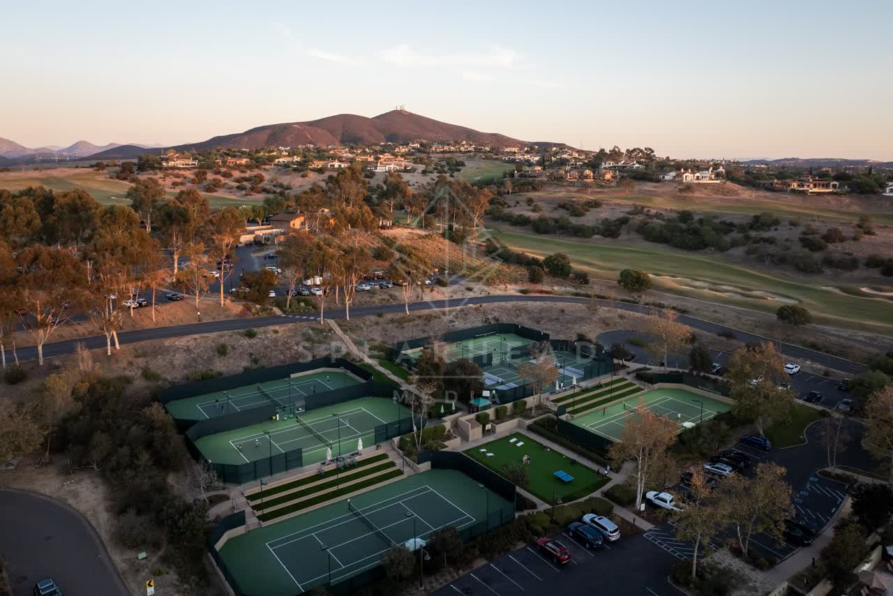 Aerial view of the country inland, homes and traffic in Santaluz, with people walking.
