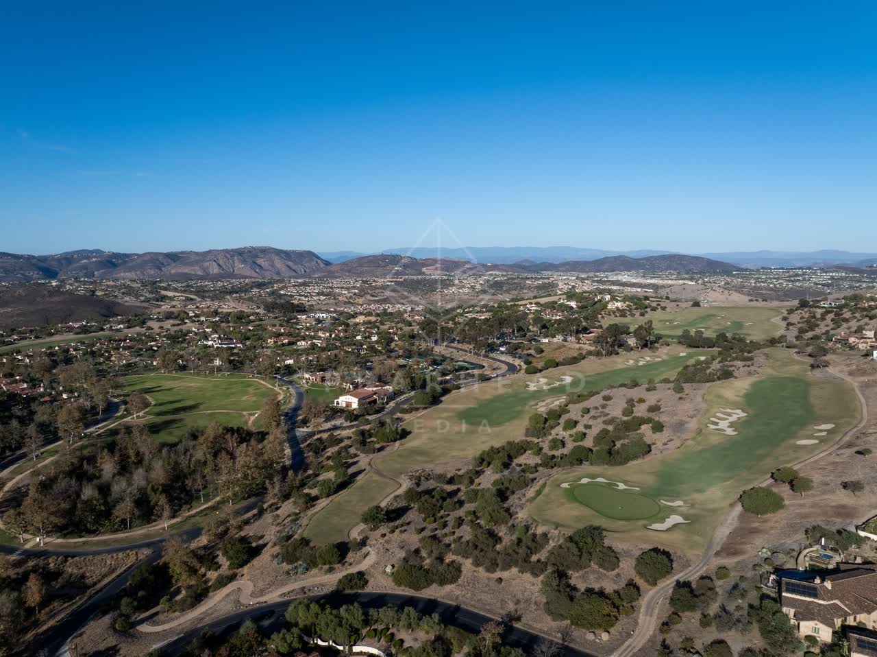Aerial view of the country inland, homes and open country in Santaluz.