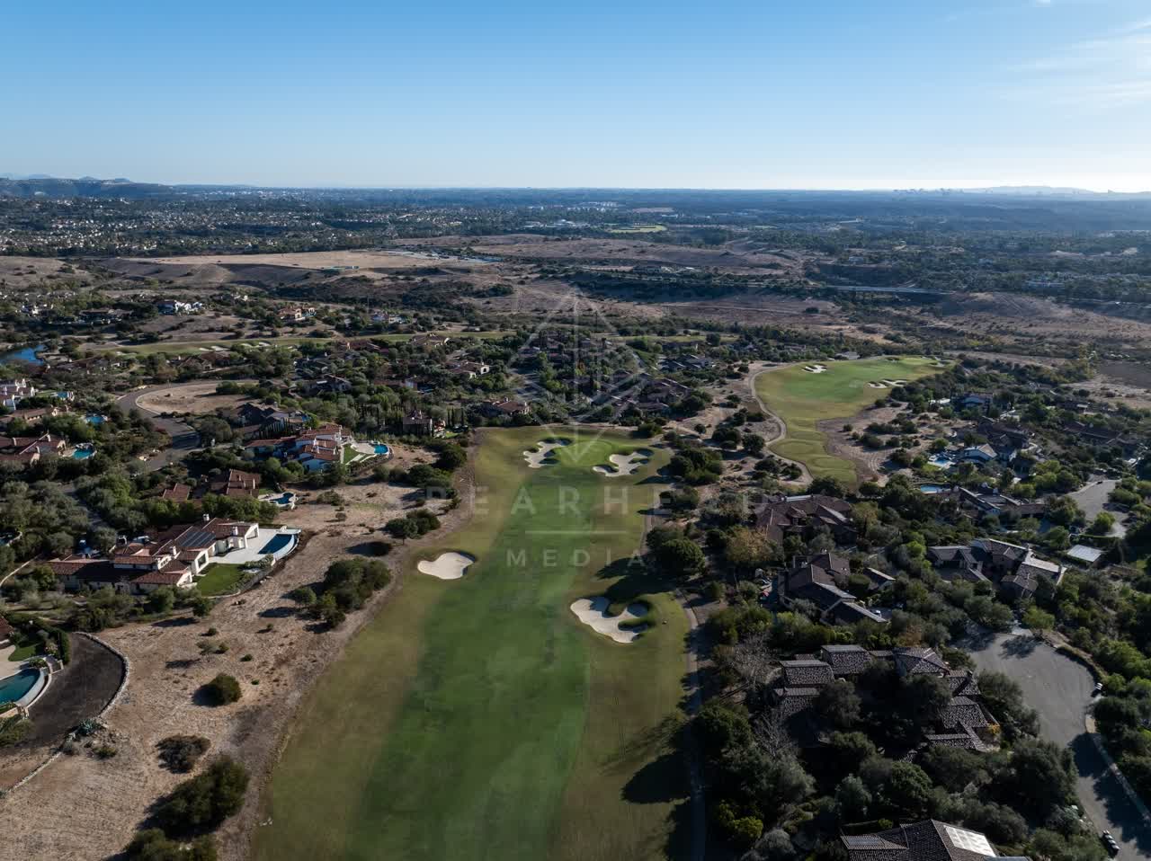 Aerial view of the country inland, homes and the buildings in Santaluz.