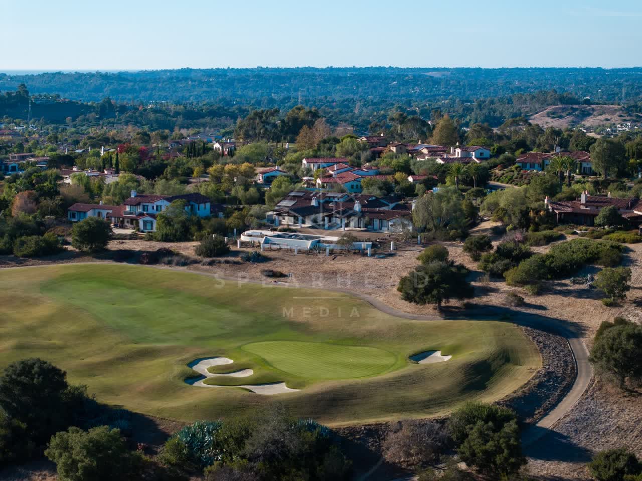 Aerial view of the country inland, palm trees and homes in Santaluz.