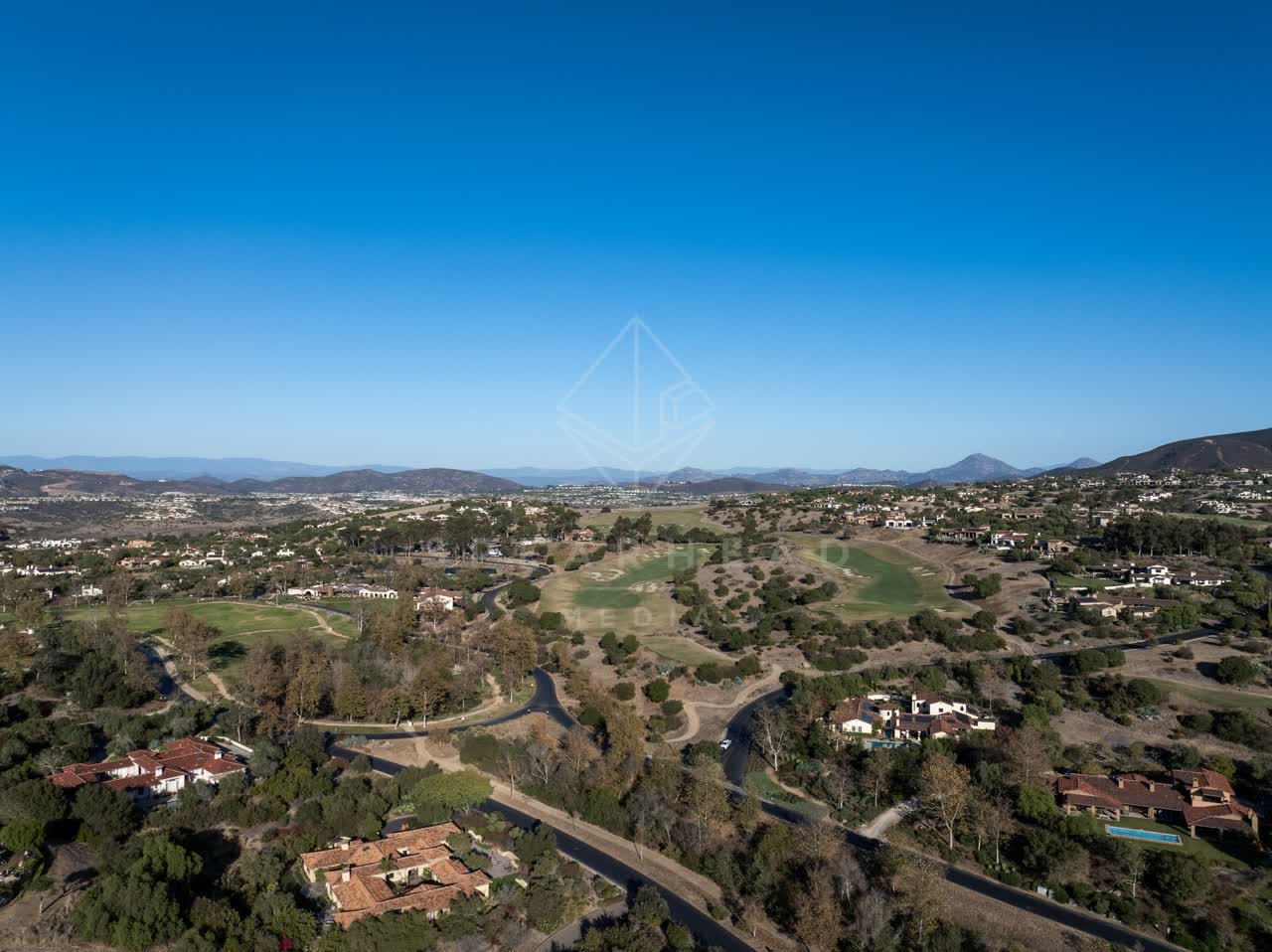 Aerial view of the country inland, homes and traffic in Santaluz.