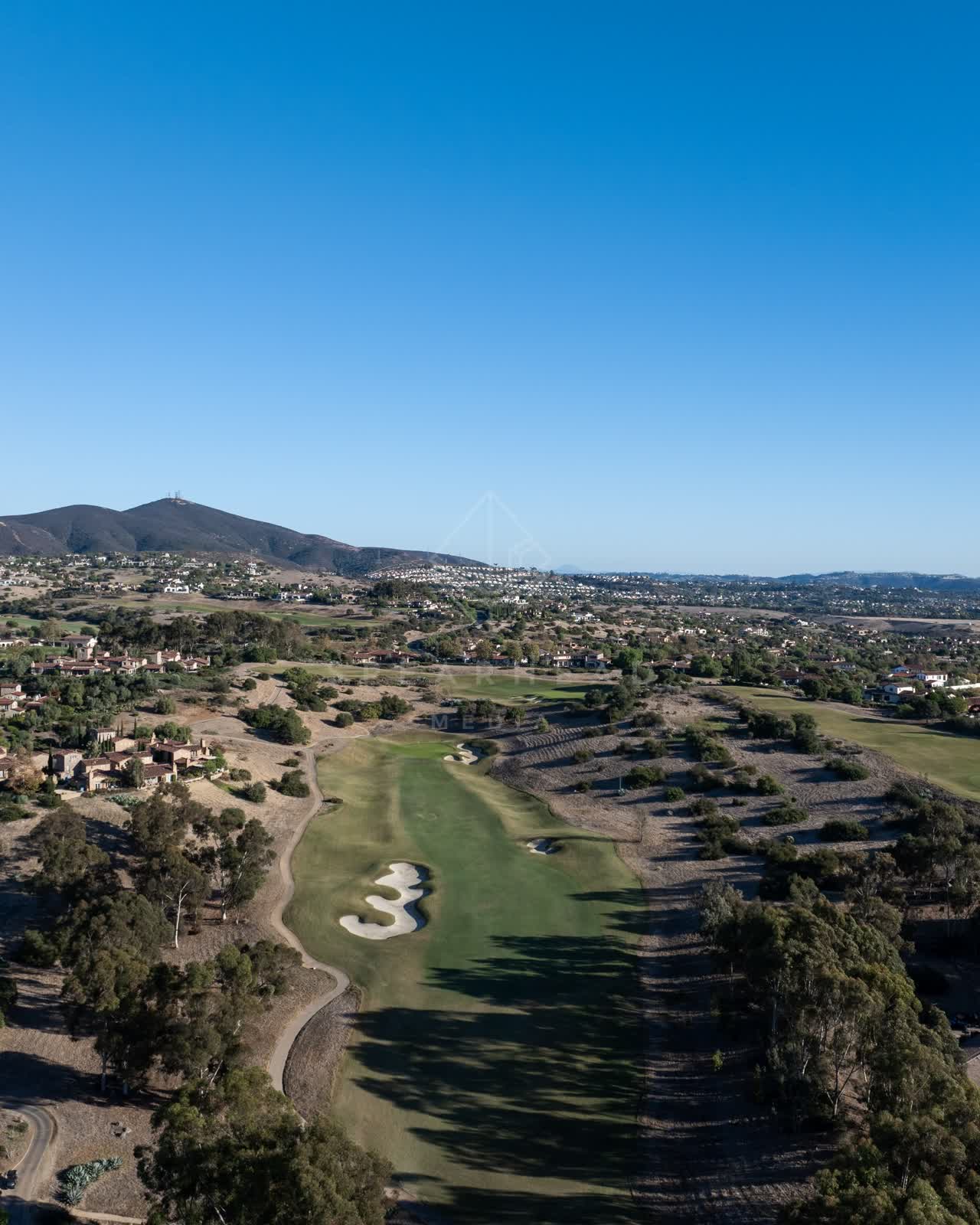Aerial view of the country inland, homes and open country in Santaluz.