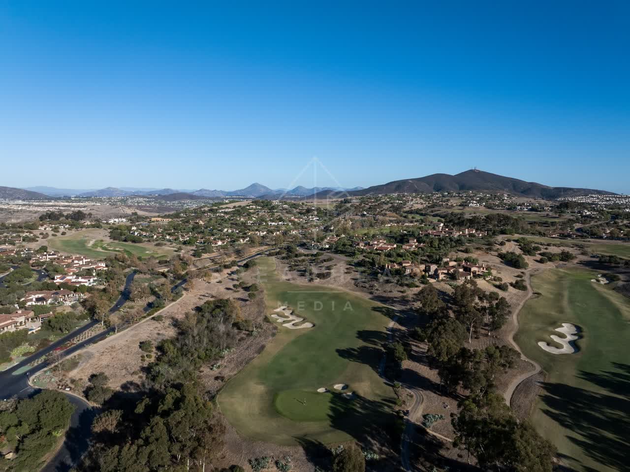 Aerial view of the country inland, homes and open country in Santaluz.