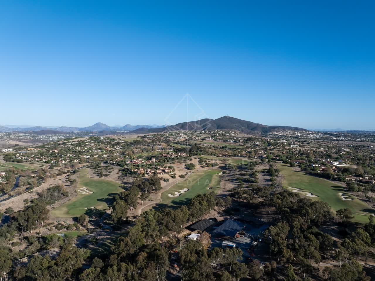 Aerial view of the country inland, homes and open country in Santaluz.
