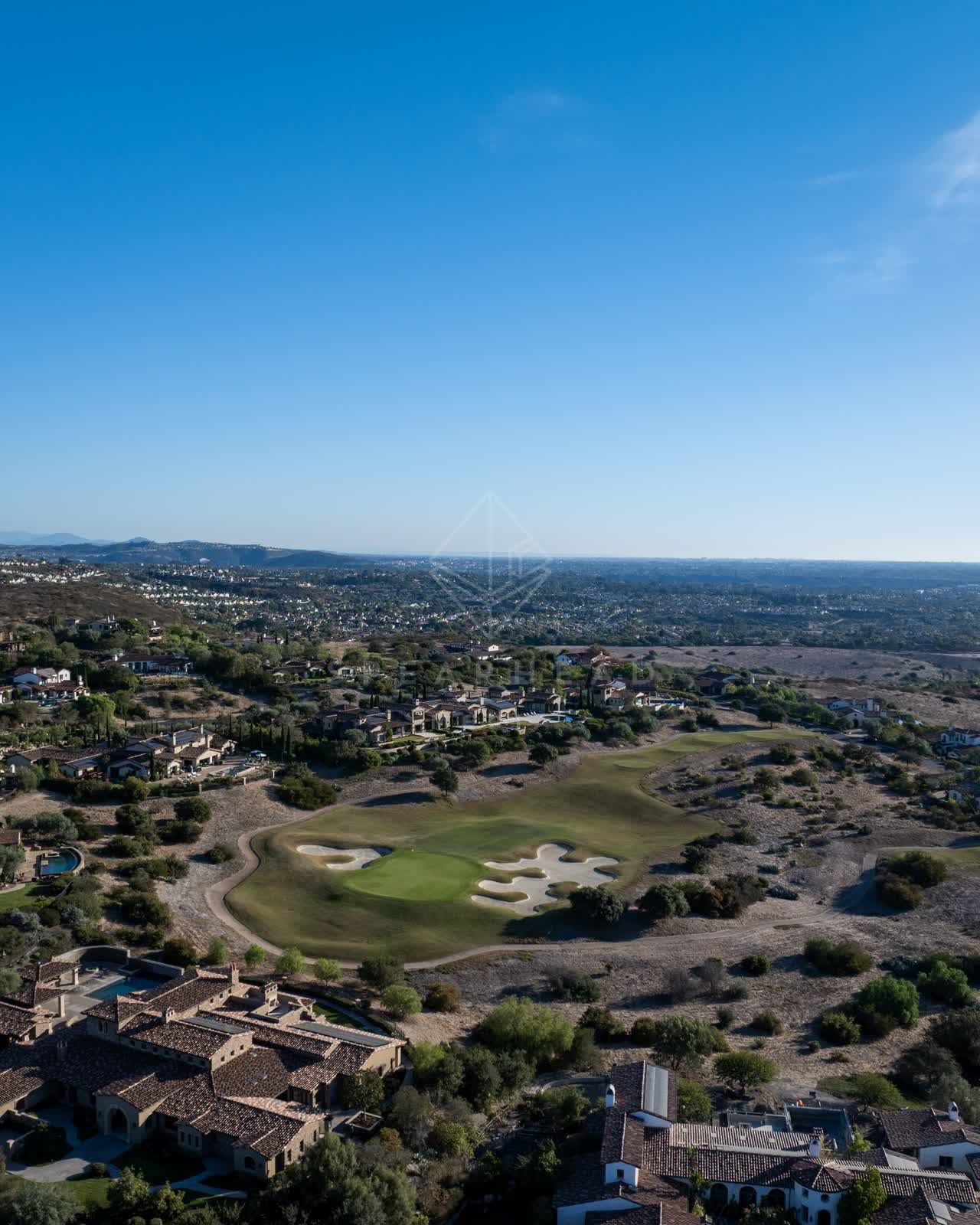 Aerial view of a residential street, homes and the buildings in Santaluz.