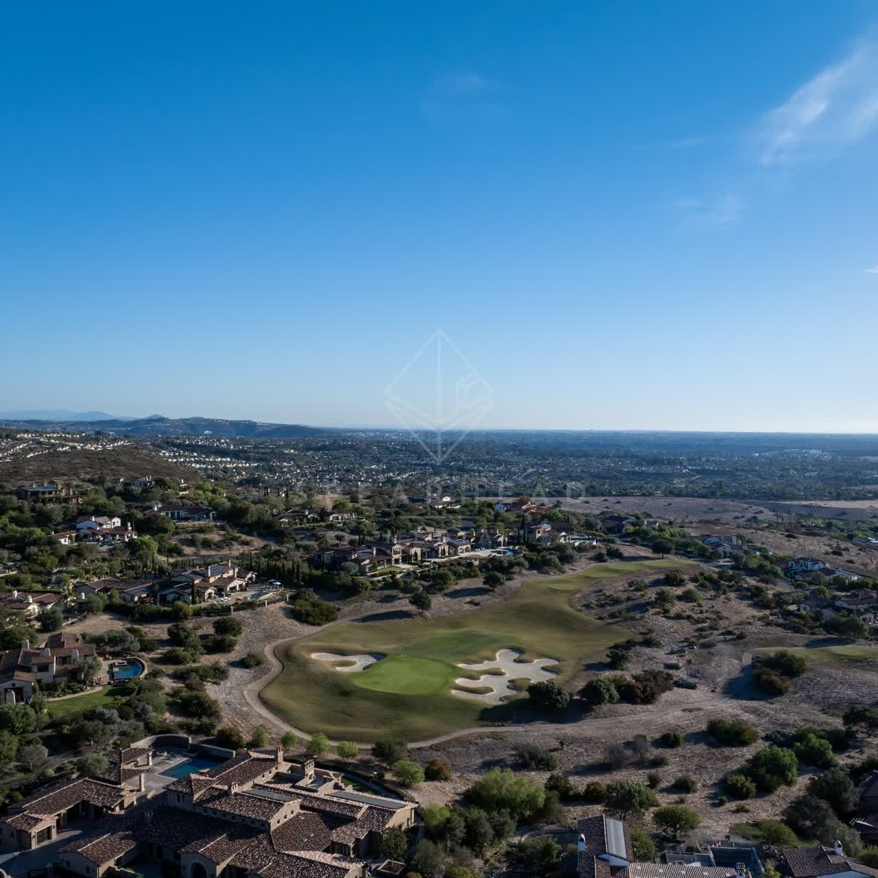 Aerial view of a residential street, homes and the buildings in Santaluz.