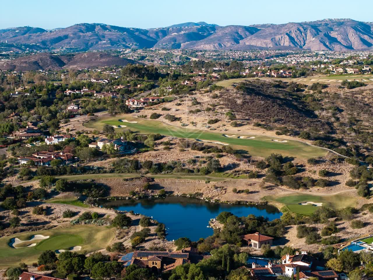 Aerial view of the country inland, homes and open country in Santaluz.