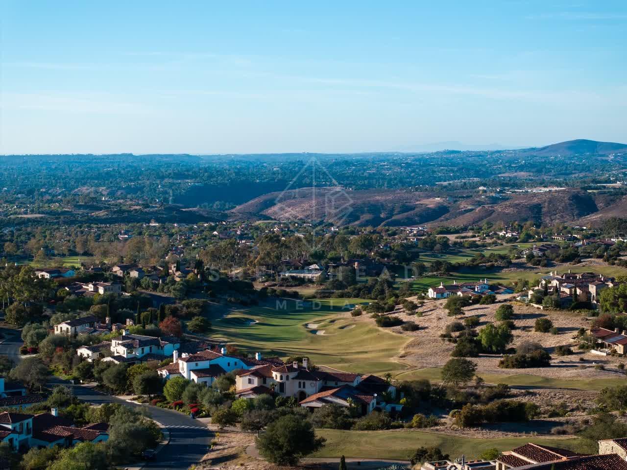 Aerial view of a residential street, homes and the buildings in Santaluz.