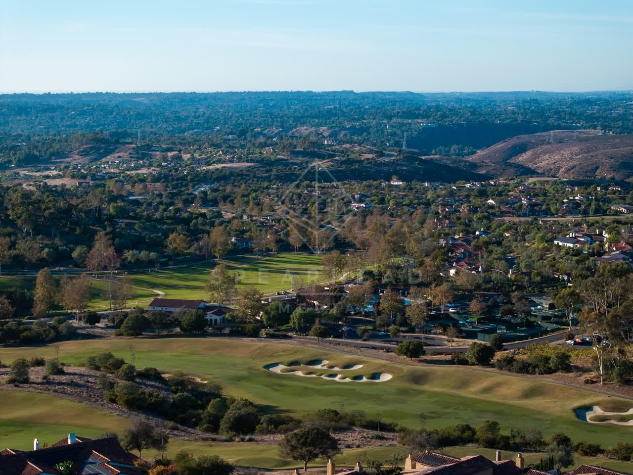 Aerial view of the country inland, homes and open country in Santaluz.